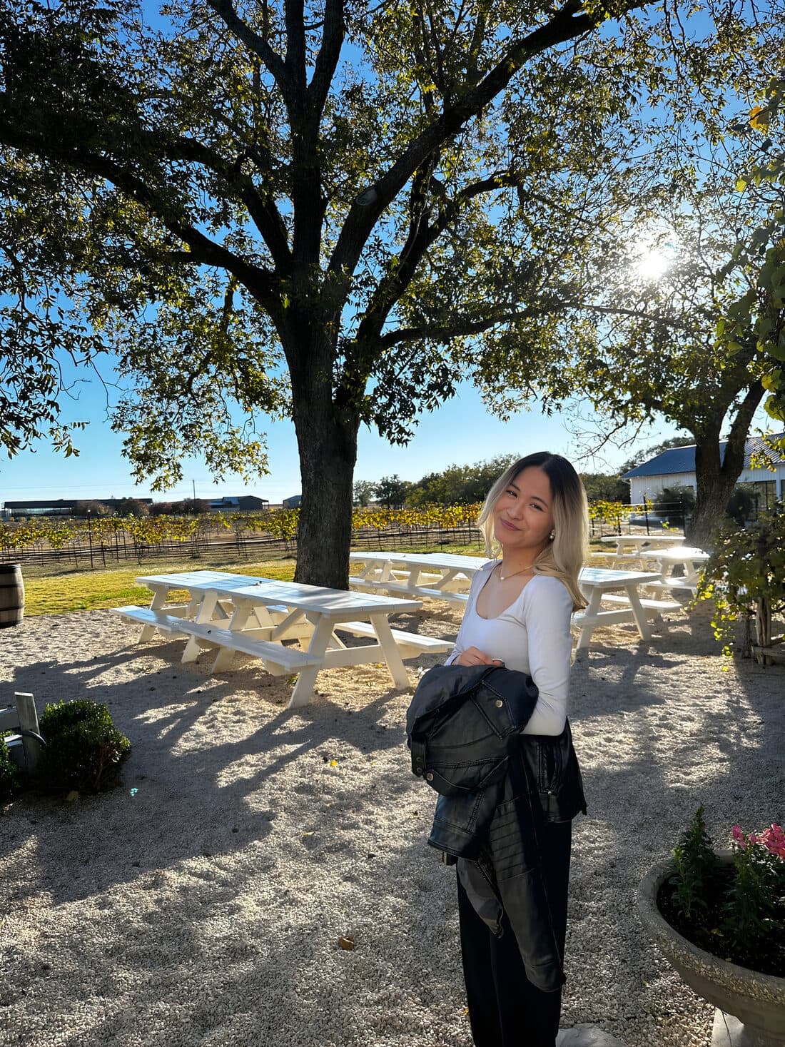 Ysabella smiling outdoors at a vineyard